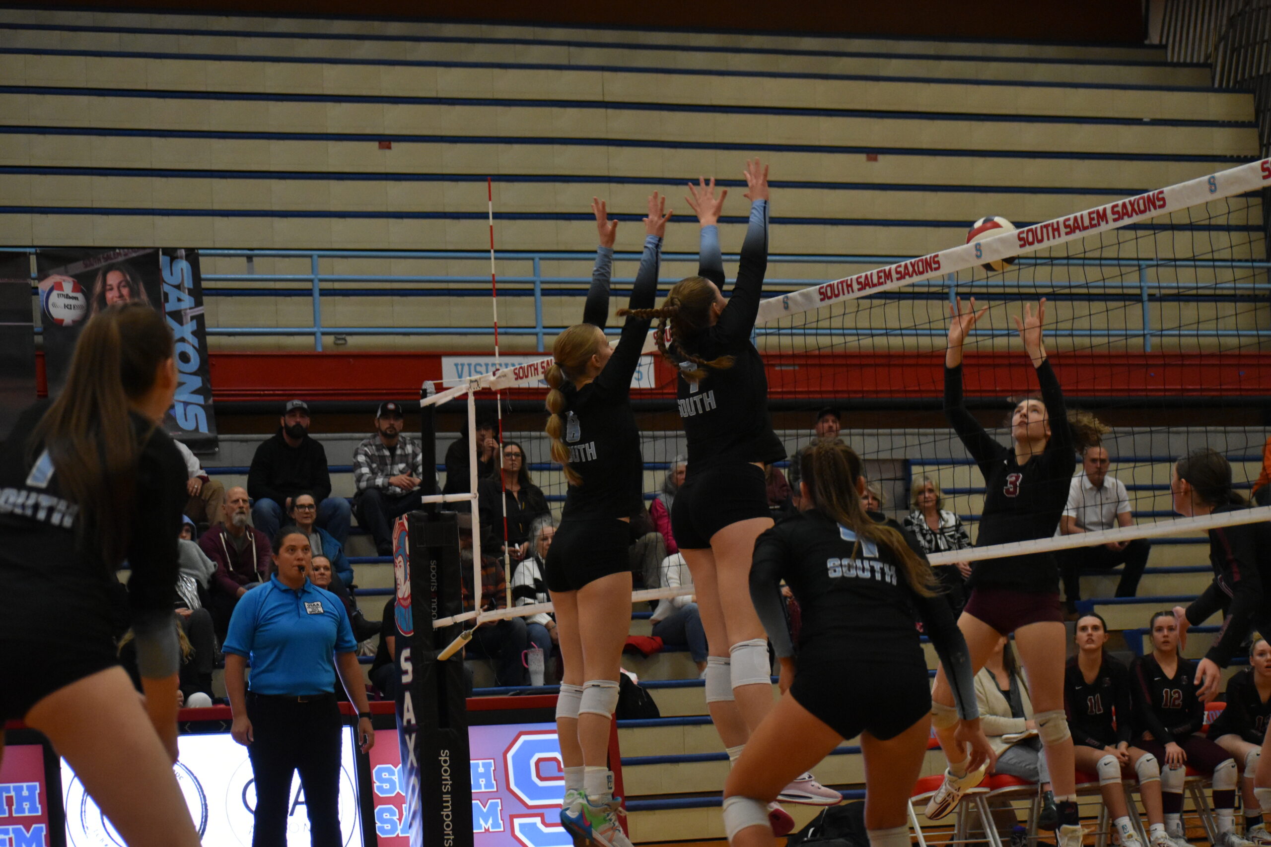 Briella Mathis '26 and Malena Mathis '24 attempt to block a shot from the opposing team.