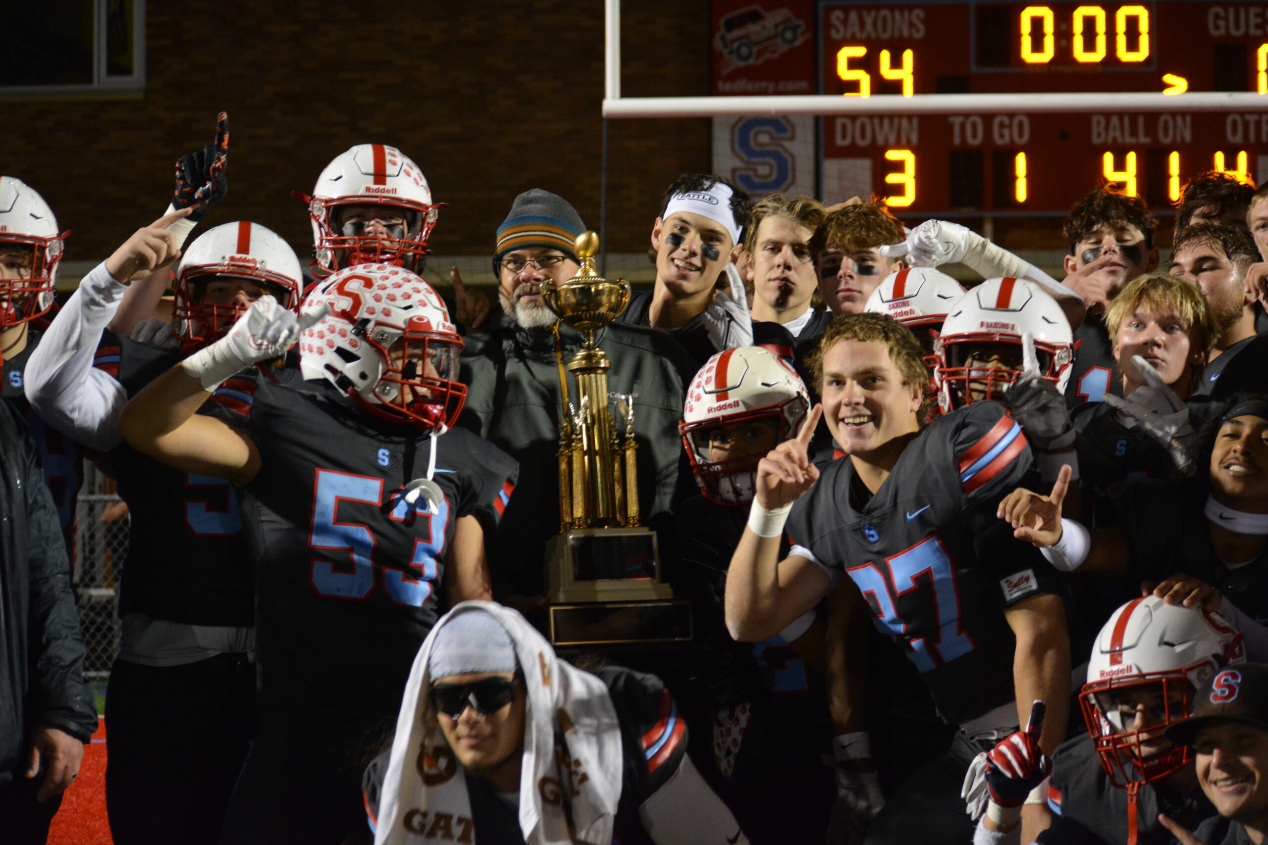 South Salem High School's varsity football team poses with the Mayor's Cup trophy after their win 54-0 win against North Salem High School.
