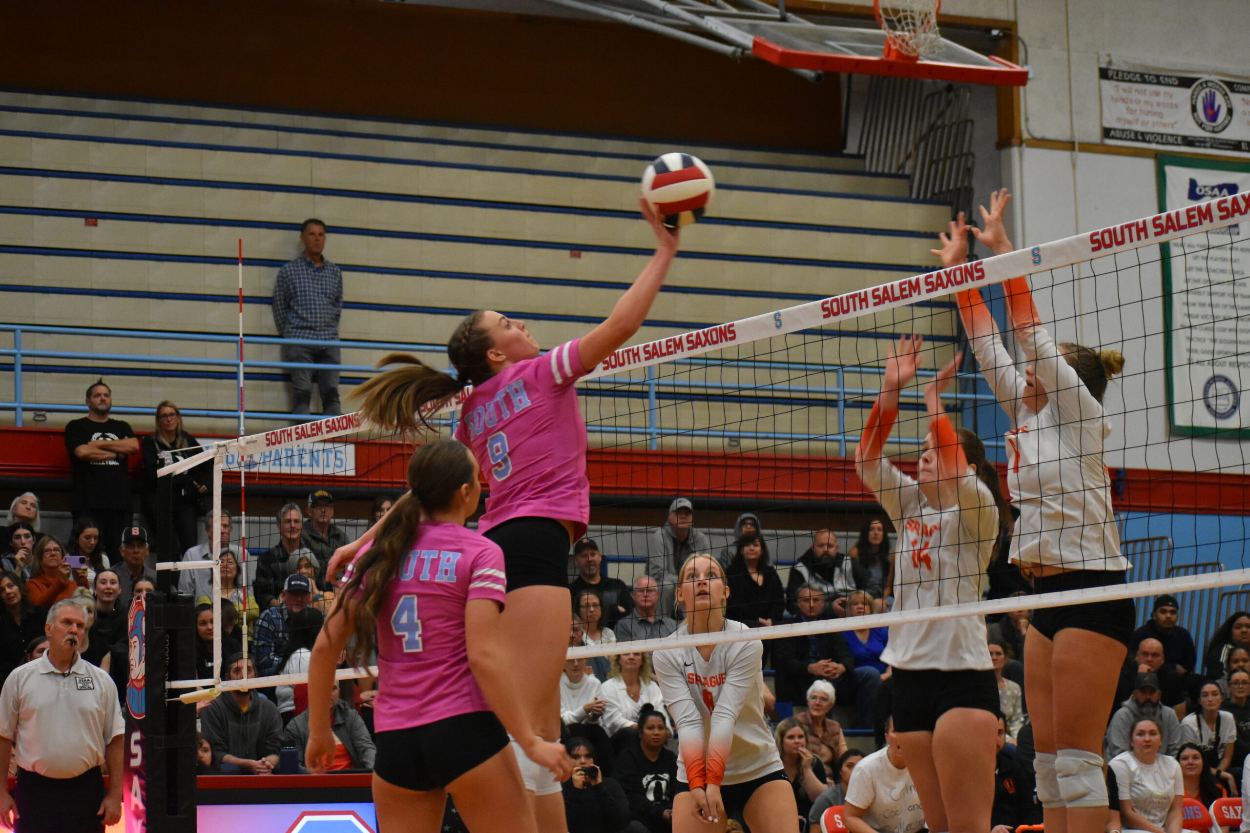 Number 9 hits the ball over the net in game against Sprague HIghschool.