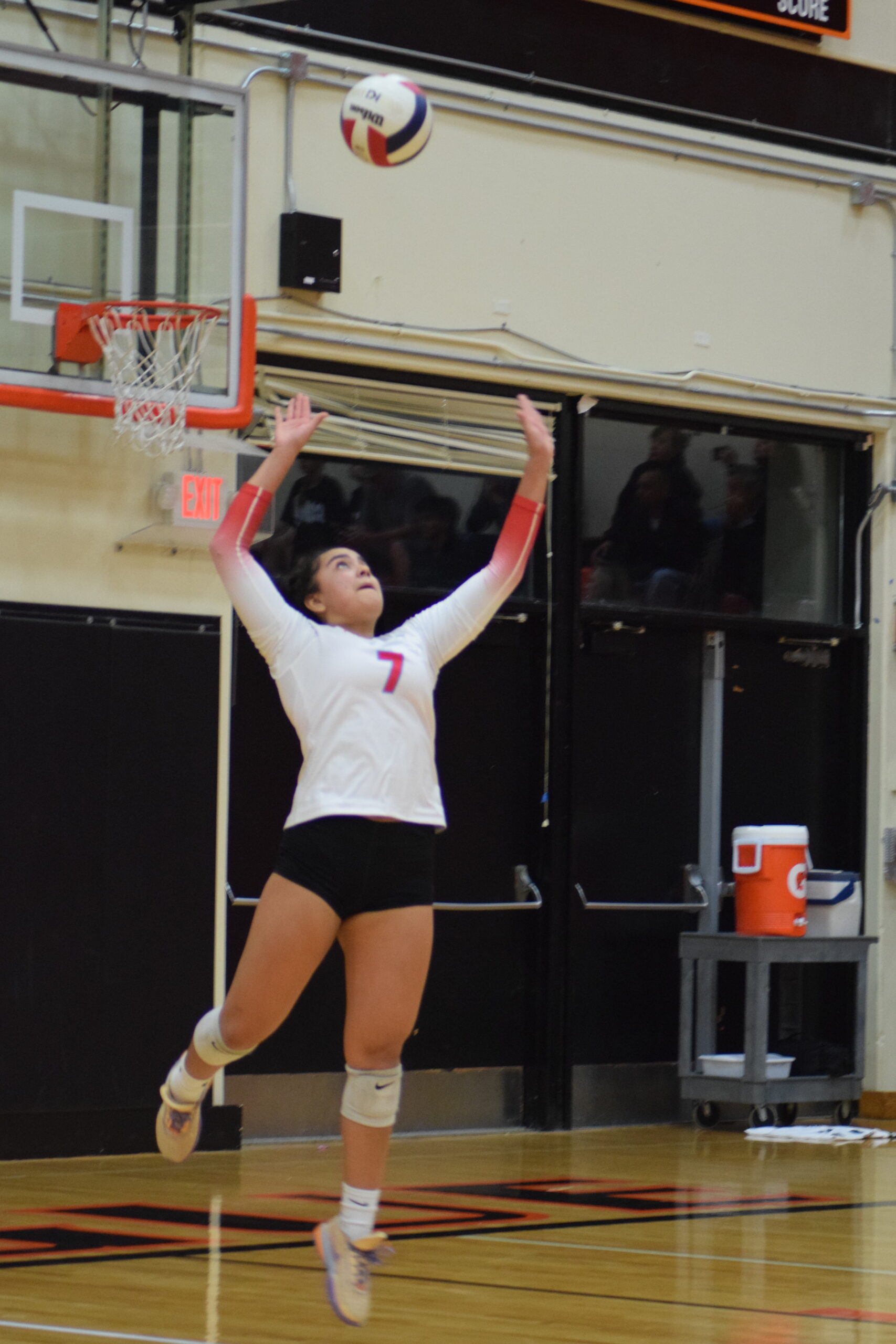 Nadiah Luna '25 of South Salem High School prepares to serves the ball in a game against Sprague High School.