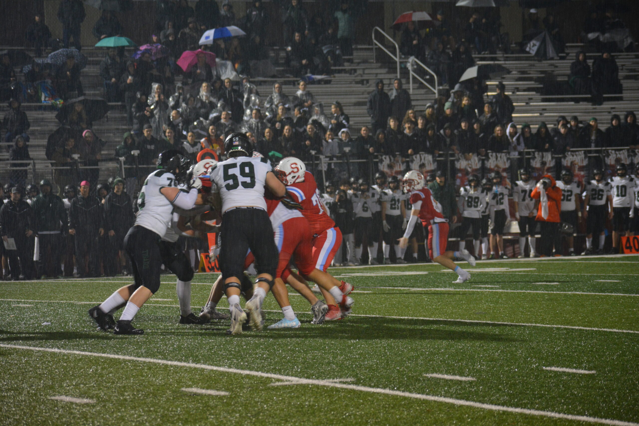 Athletes from Tigard High School and South Salem High School fight for control on the ball during a first-round playoff game.