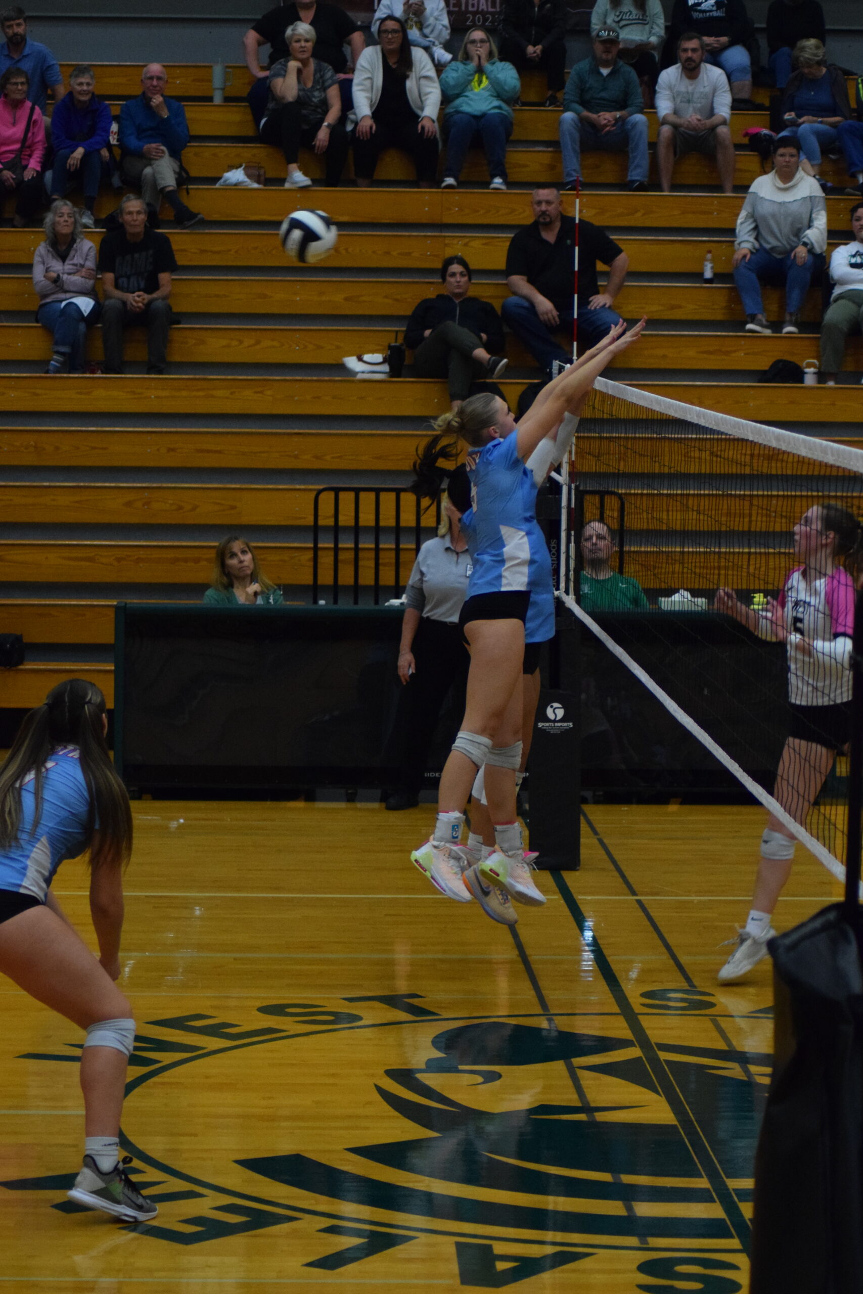 Brooklyn Butler '25 defends the net in a game against West Salem High School.