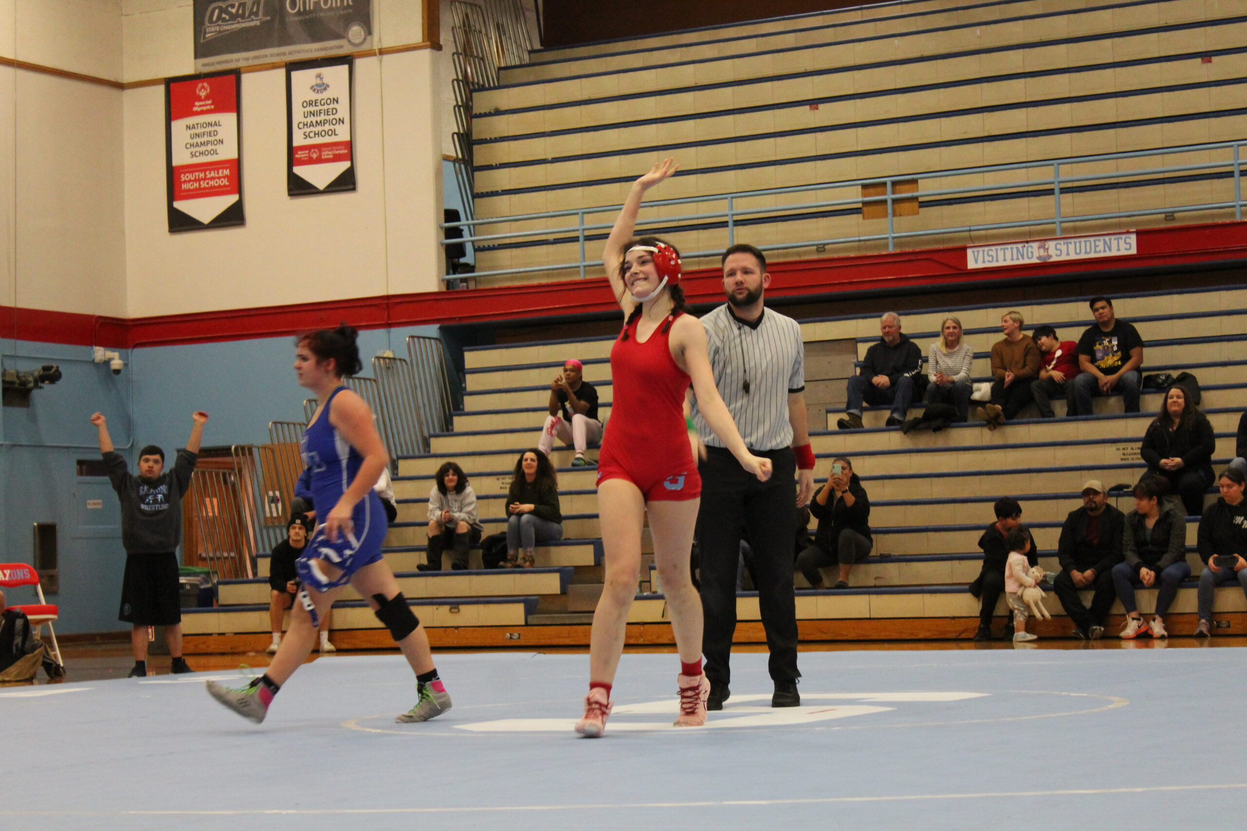South Salem High School's Alexis Rojas '23 emerges victorious from her wrestling match against an opponent from McNary High School.