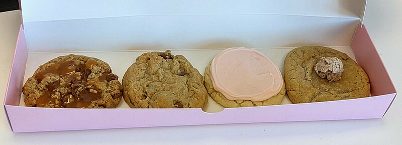 A photo of an open box of Crumbl Cookies