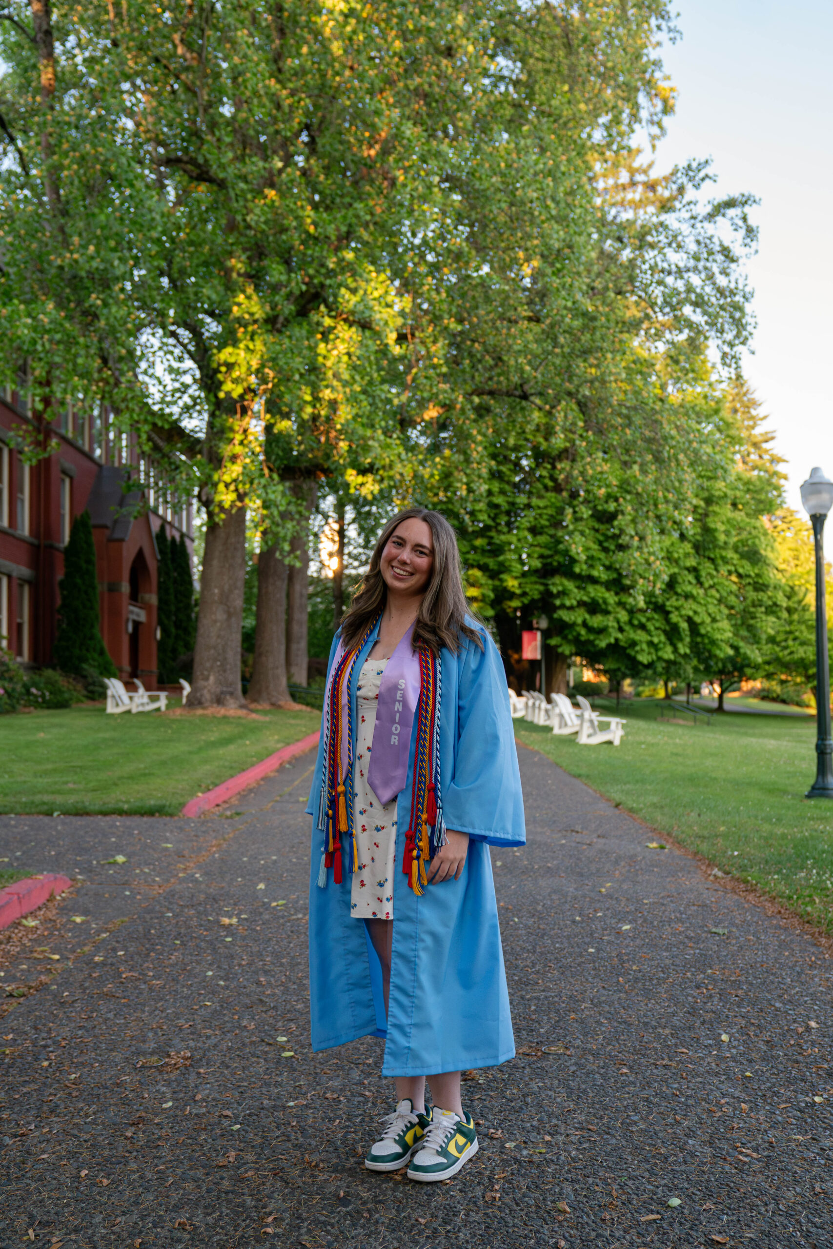 Lily Squires Posing for a Photo in her Cap and Gown